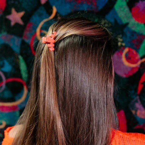 Doodlations Coffee Bar & Boutique coral segmented hair claw clip for secure updos and everyday wear.