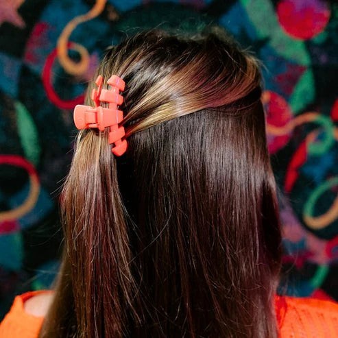 Doodlations Coffee Bar & Boutique coral segmented hair claw clip for secure updos and half-up styles.