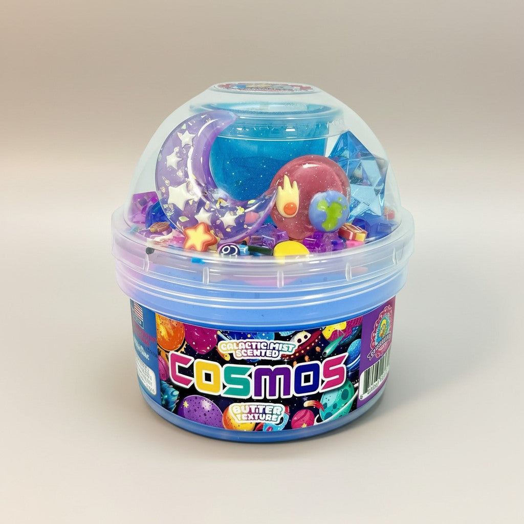Doodlations Coffee Bar & Boutique Cosmos slime in a blue tub with galaxy-themed charms, glitter, and stars.