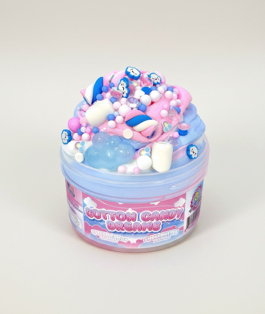 Doodlations Cotton Candy Dreams snow butter slime swirled pink, blue, white with cloud charms, marshmallows, and floam beads.