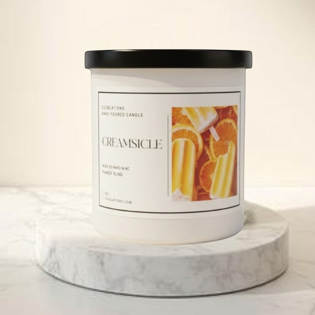 Doodlations Creamsicle hand-poured candle with orange and popsicle design. Citrus scent.