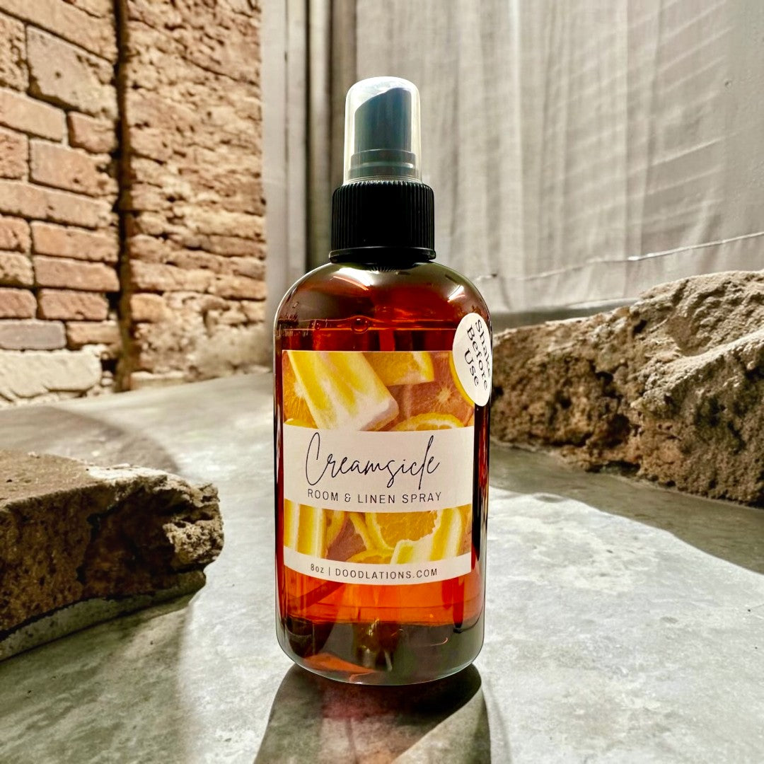 Doodlations Coffee Bar & Boutique Creamsicle Room & Linen Spray with citrus fruit design. 8oz bottle.