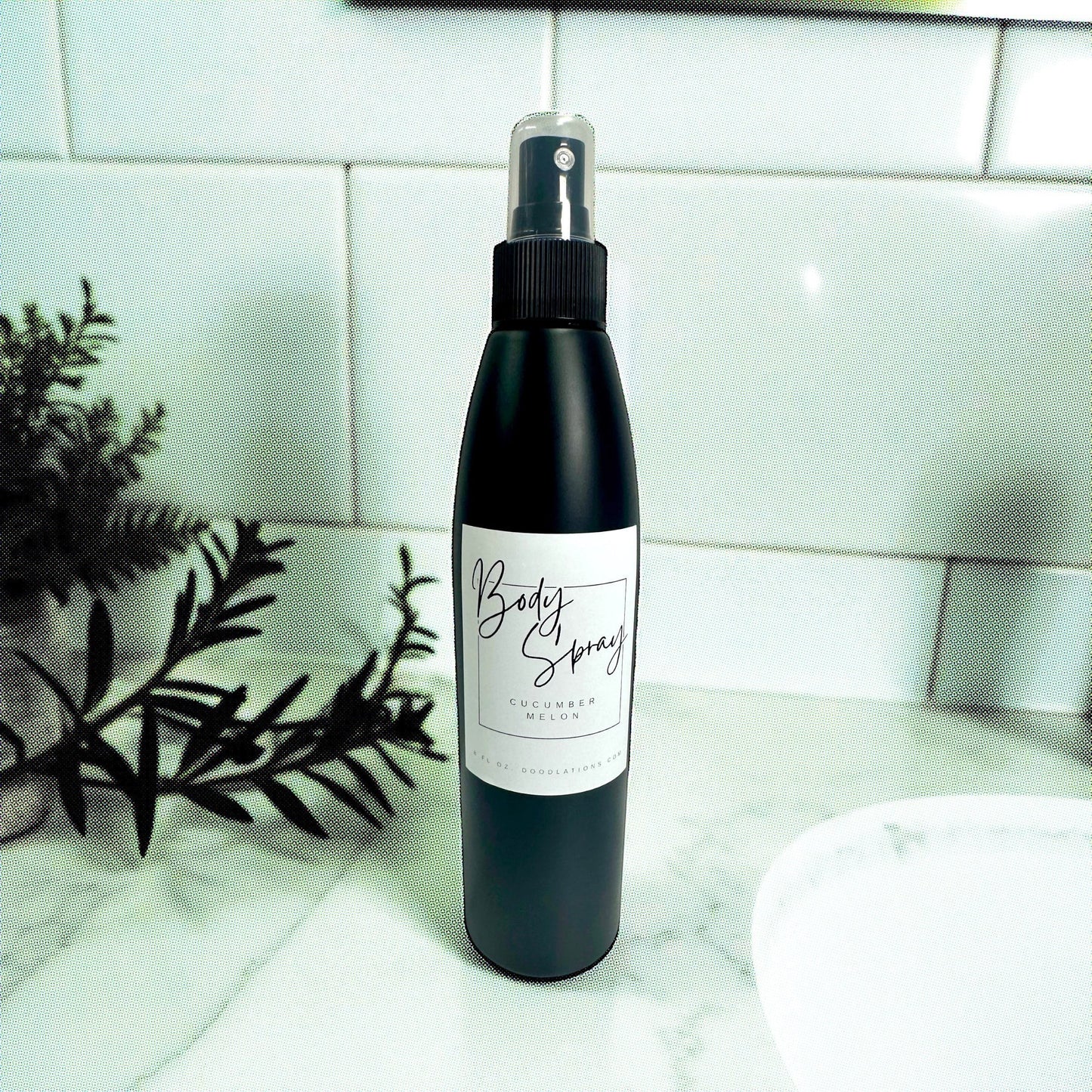 Doodlations Coffee Bar & Boutique black bottle of Cucumber Melon moisturizing body spray with aloe and hydrating butters.