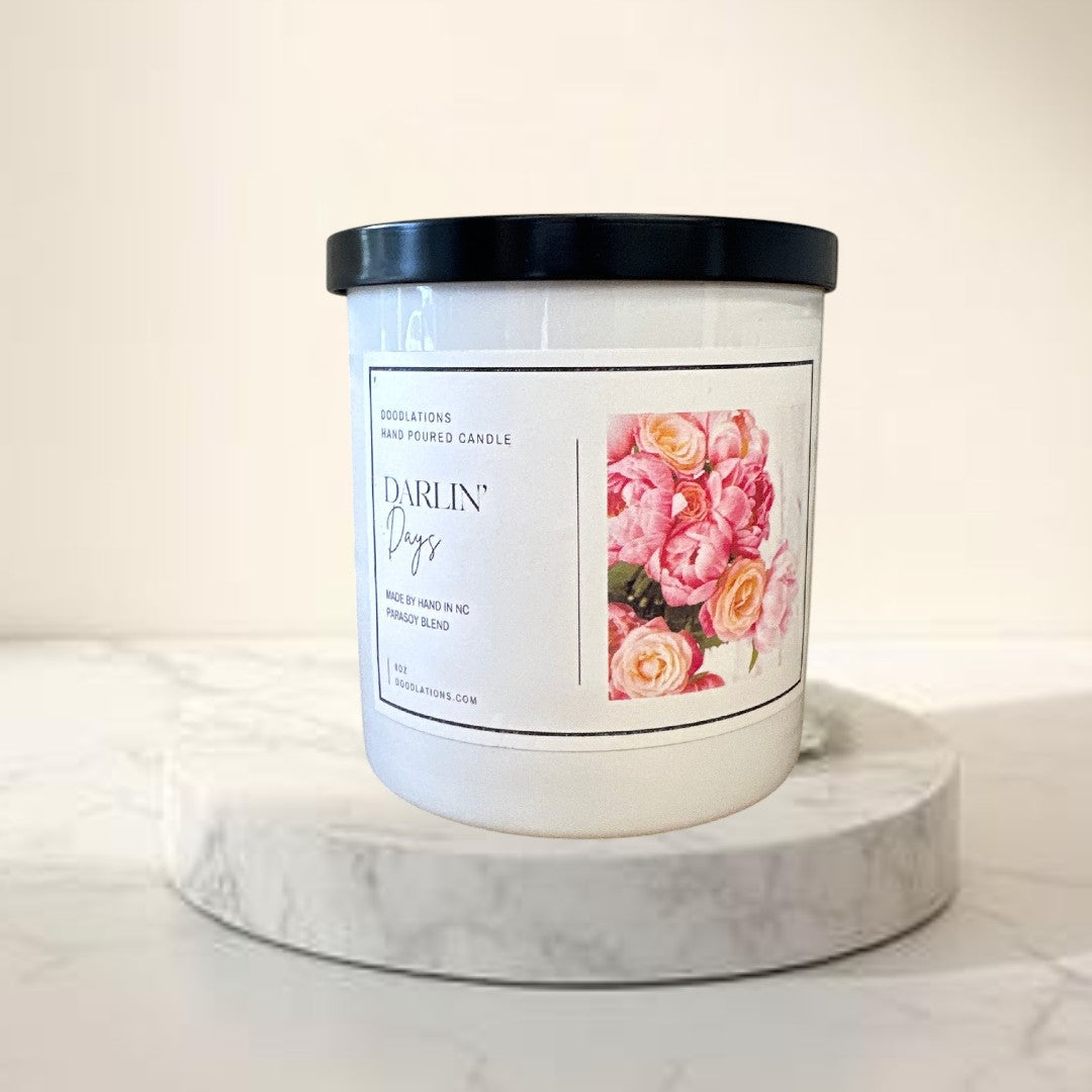 Doodlations Darlin' Days hand-poured soy blend candle with a floral label and black lid.