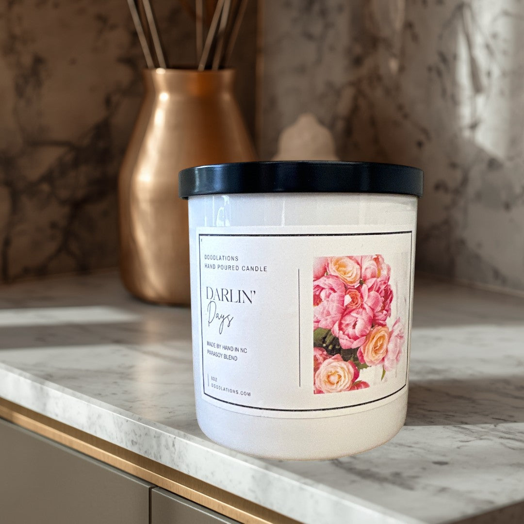 Doodlations Darlin' Days hand-poured soy blend candle with a floral label and black lid.