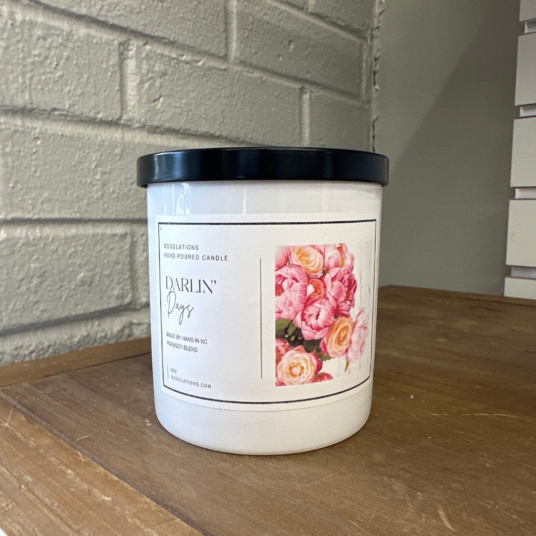 Doodlations Darlin' Days hand-poured soy blend candle with a floral label and black lid.