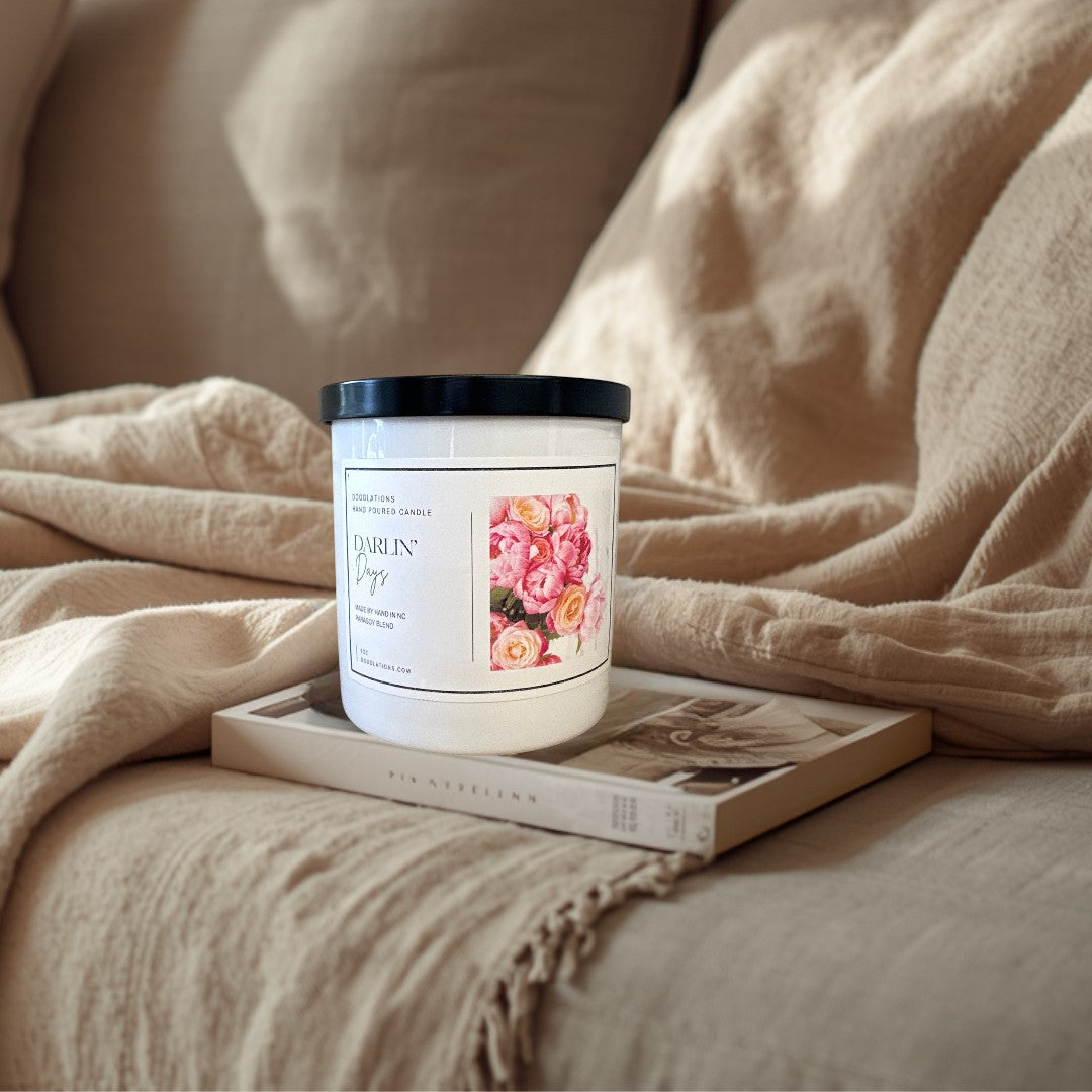 Doodlations Darlin' Days hand-poured soy blend candle with a floral label and black lid.
