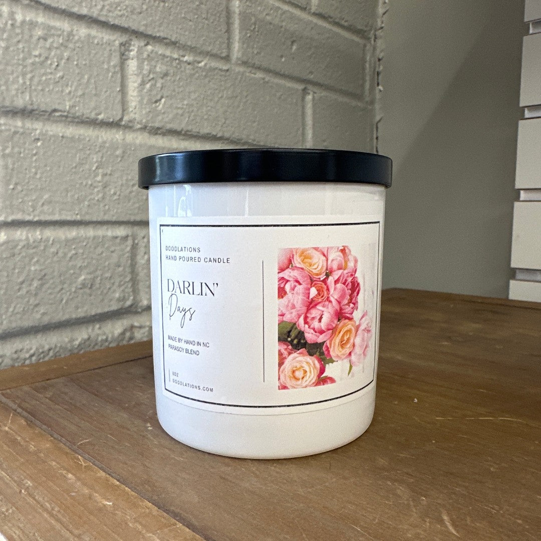Doodlations Darlin' Days hand-poured soy blend candle with a floral label and black lid.