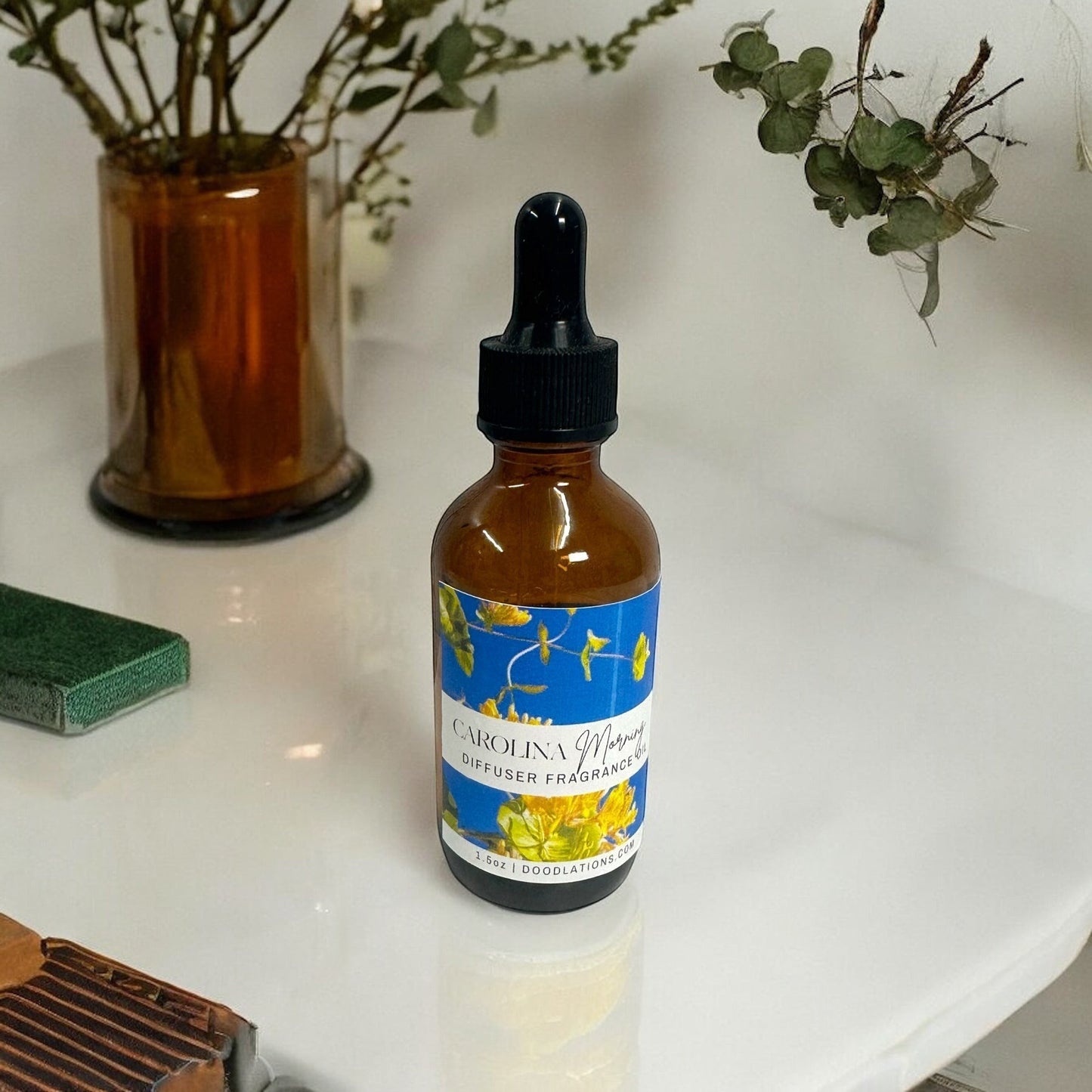 Doodlations Coffee Bar & Boutique Carolina Morning diffuser fragrance oil in amber glass bottle with dropper.