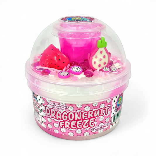 Doodlations Dragonfruit Freeze slime in a clear container, featuring hot pink slime with white cloud texture, topped with dragonfruit charms, jelly cubes, and sprinkles.