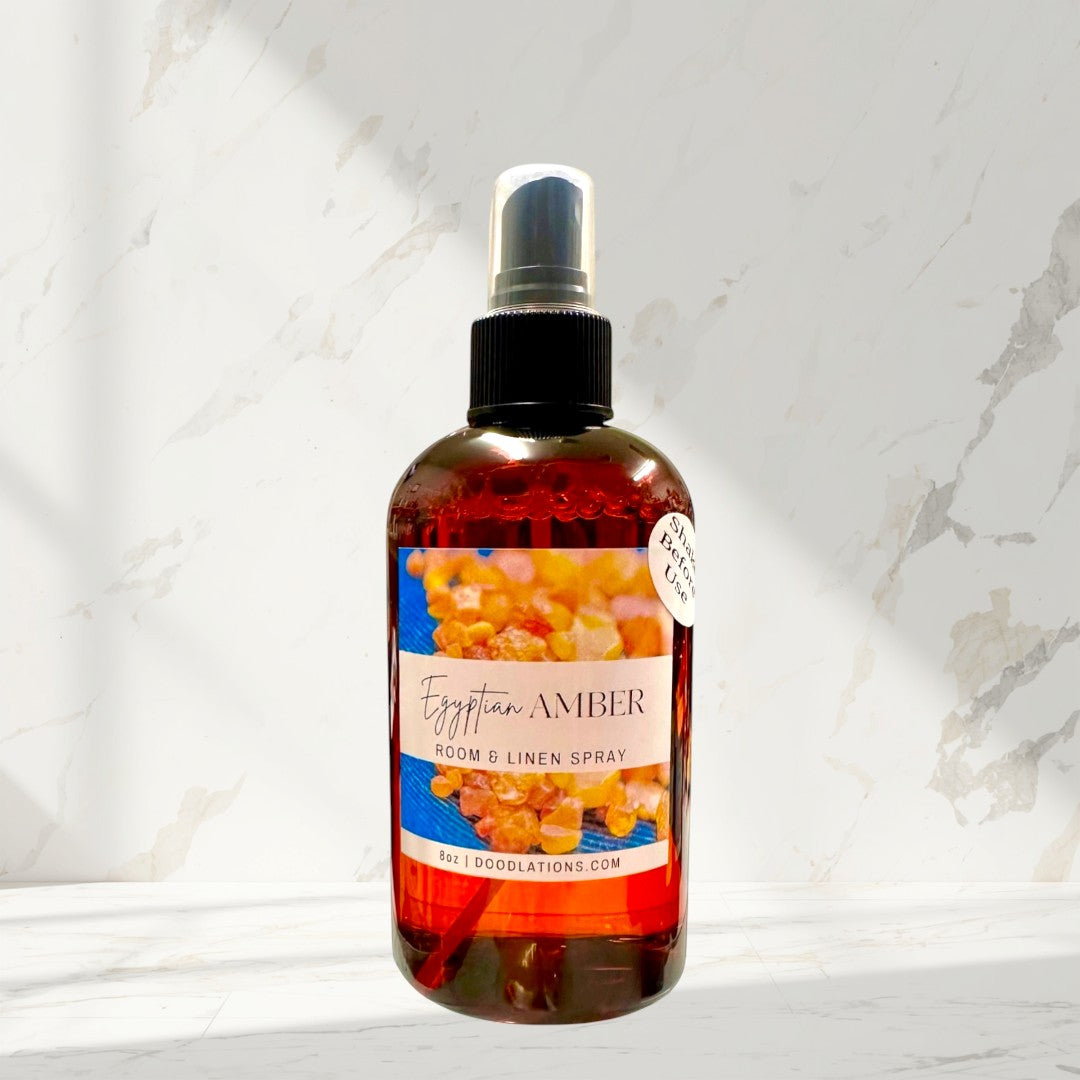 Doodlations Coffee Bar & Boutique Egyptian Amber room and linen spray in amber bottle with spray top. Scent notes include amber, jasmine, vanilla, musk, sandalwood, and citrus.