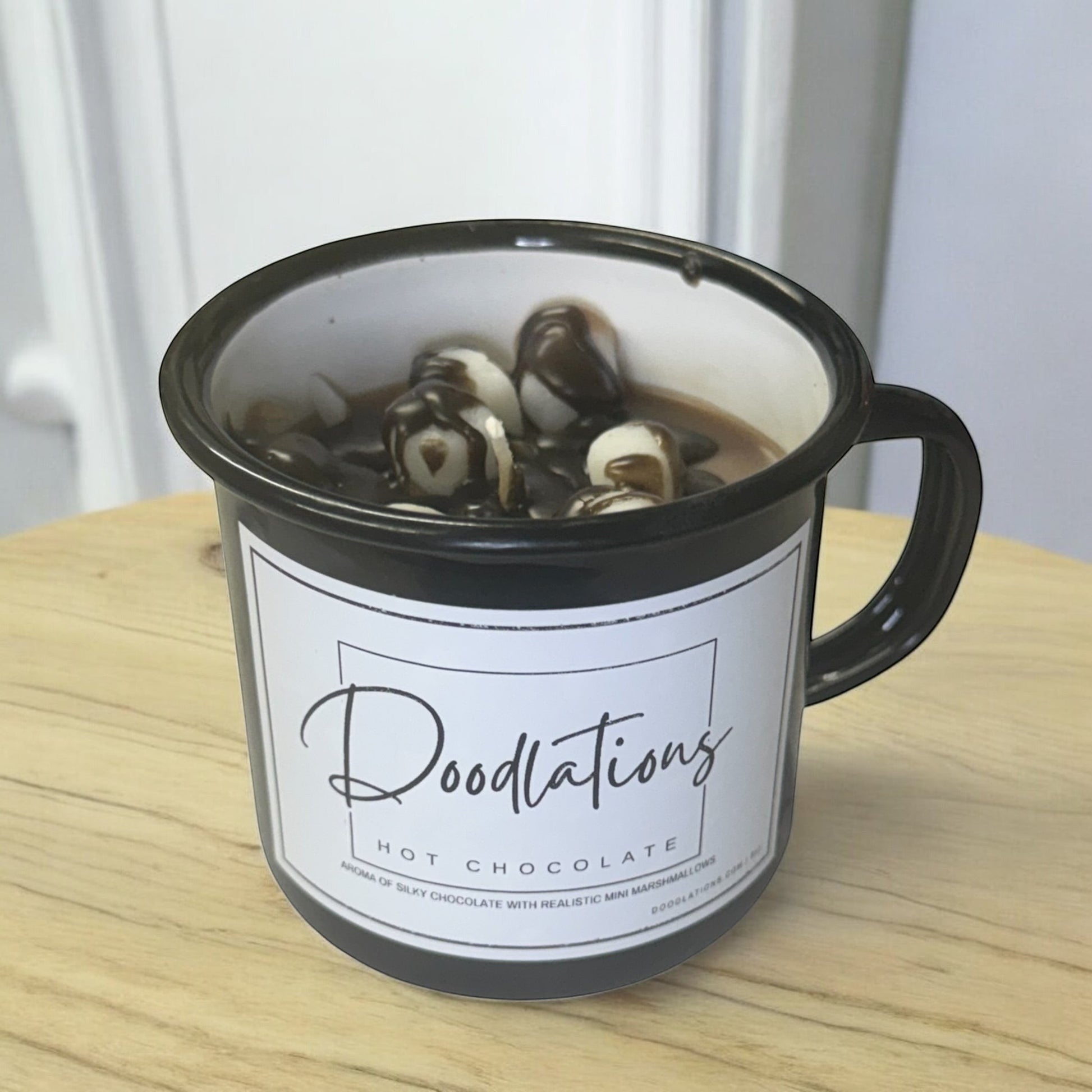 Doodlations black enamel camping mug candle with hot chocolate scent and realistic mini marshmallows.