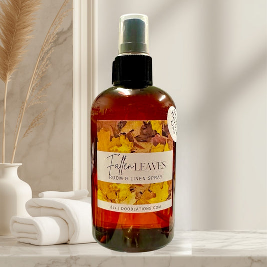Doodlations Coffee Bar & Boutique Fallen Leaves room and linen spray in amber bottle with fall leaf label. Warm, inviting autumn scent.
