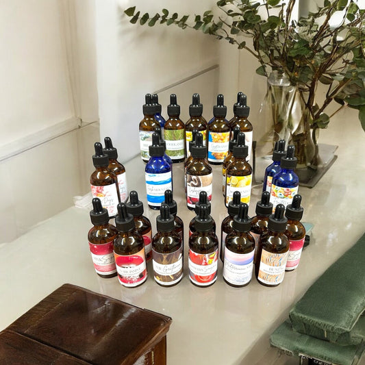 Doodlations Coffee Bar & Boutique Artisan Diffuser Fragrance Oil Collection bottles with dropper tops. Assorted scents and colors.