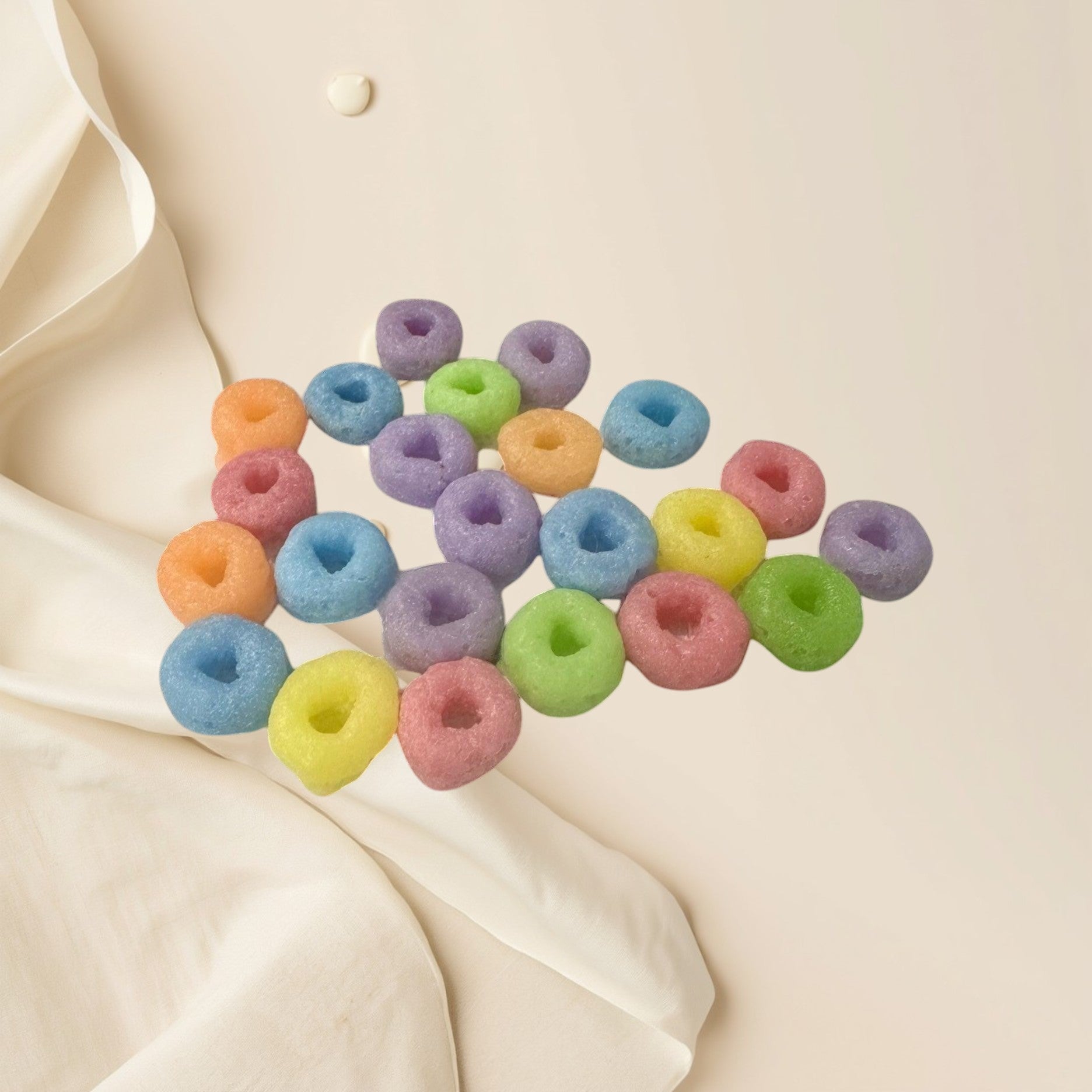 Doodlations Coffee Bar & Boutique Fruit Loops wax melts in pastel orange, blue, pink, yellow, purple, and green.
