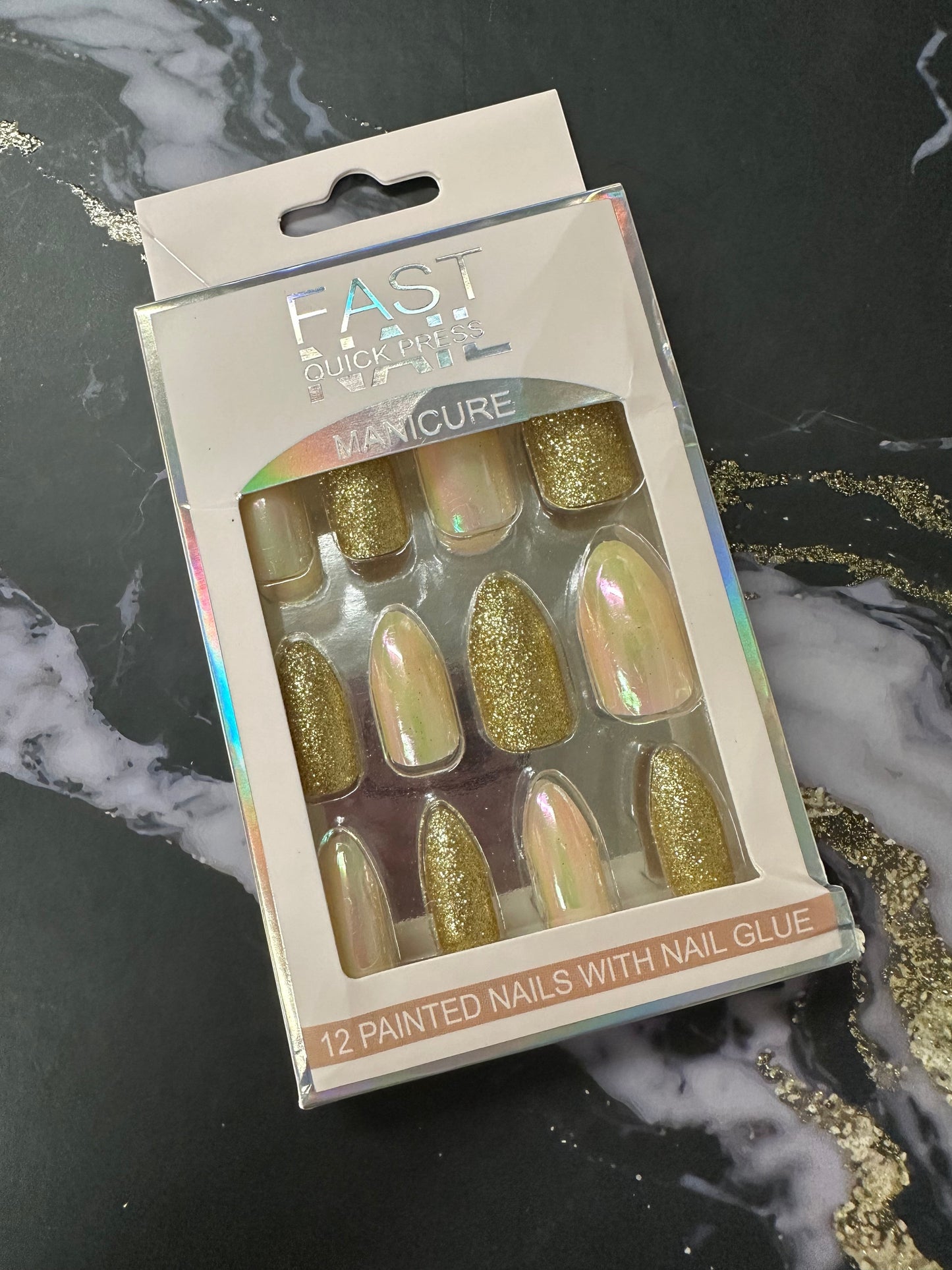 Doodlations Coffee Bar & Boutique Fast Nails Quick Press Manicure set with 12 painted nails in gold glitter and iridescent finishes.