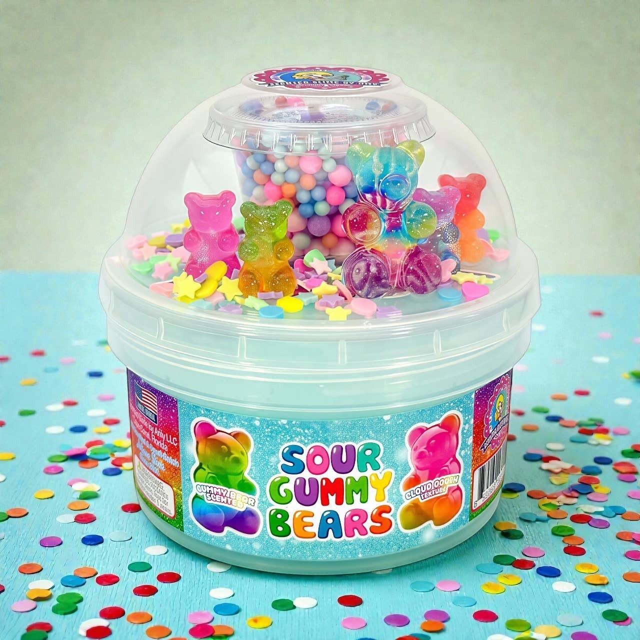 Doodlations Sour Gummy Bear Slime kit with light blue cloud slime, colorful gummy bear charms, star confetti, and foam beads.