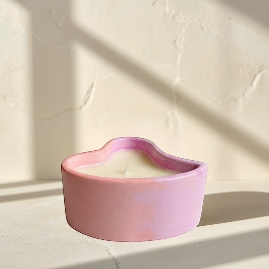 Doodlations Coffee Bar & Boutique heart-shaped concrete candle with pink and purple marbled finish, filled with creamy soy wax.