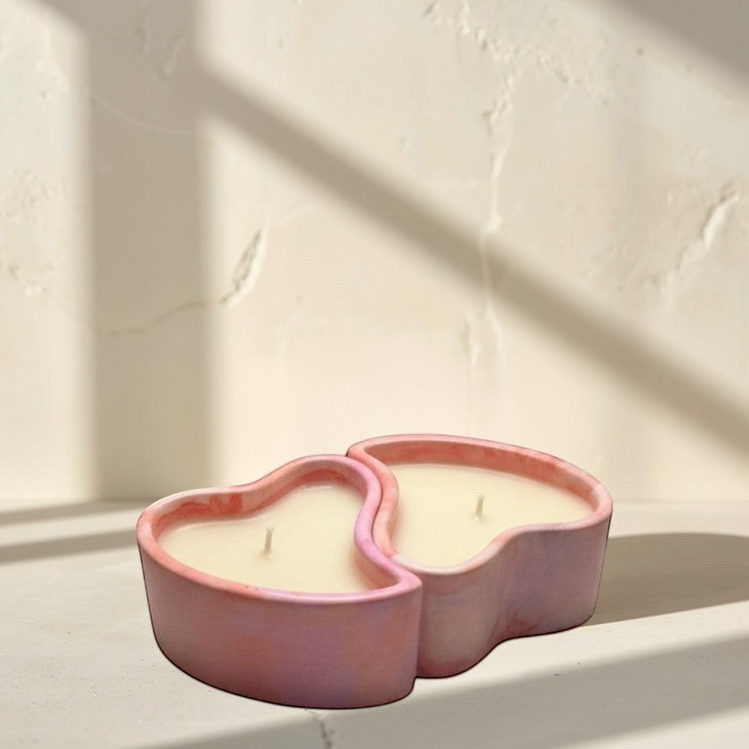 Doodlations Coffee Bar & Boutique heart-shaped concrete candle with pink and purple marbled finish, filled with creamy white soy wax.