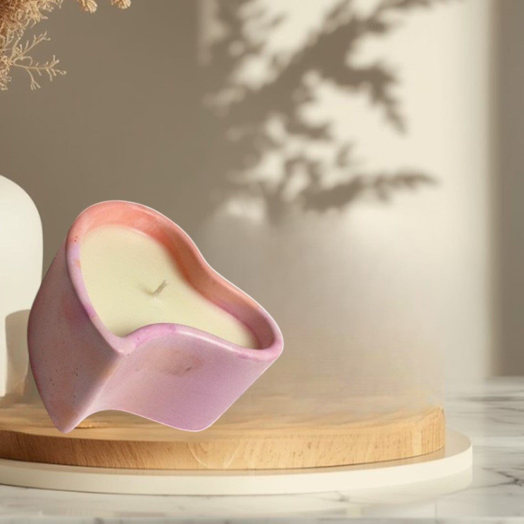 Doodlations Coffee Bar & Boutique heart-shaped concrete candle with pink and purple marbled finish, filled with creamy soy wax.
