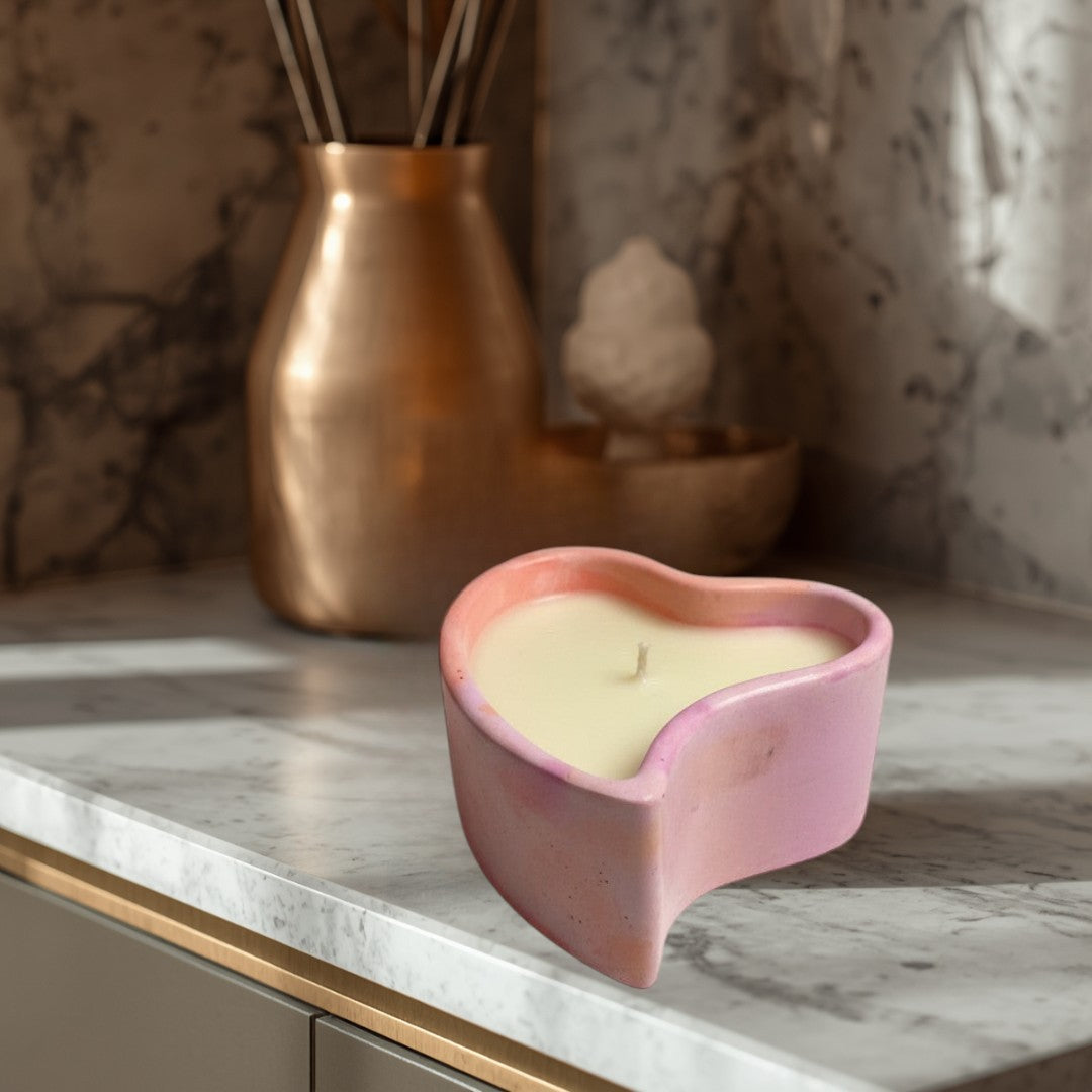 Doodlations Coffee Bar & Boutique heart-shaped concrete candle with pink and purple marbled finish, filled with creamy soy wax.