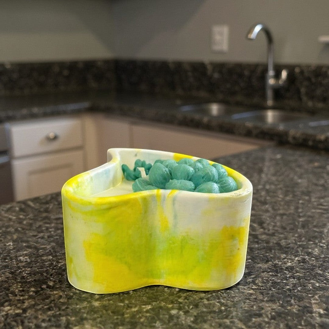 Doodlations yellow and white marbled heart concrete candle with teal wax melts.