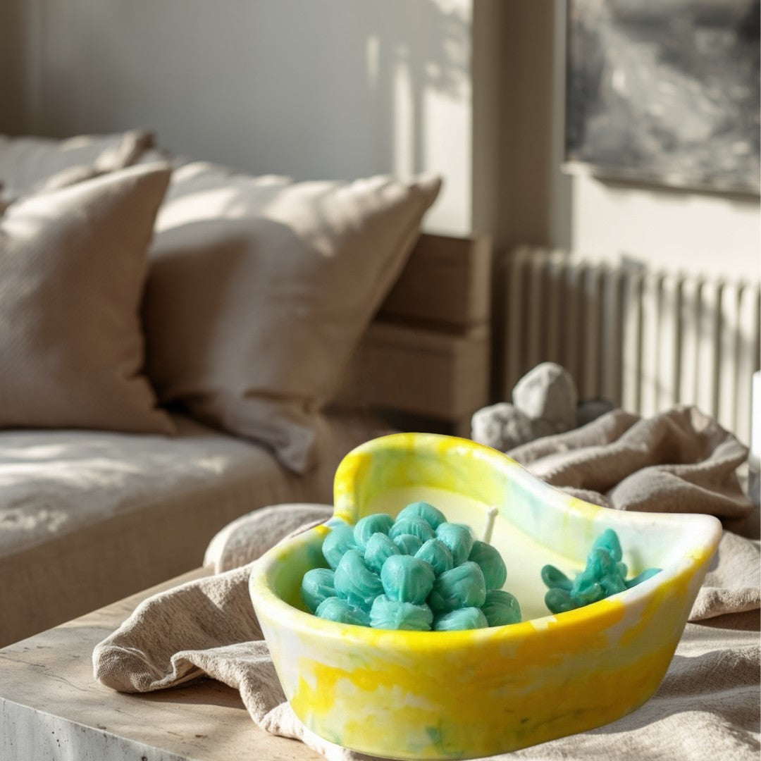 Doodlations hand-poured heart concrete candle with teal succulent design and yellow marbled vessel.