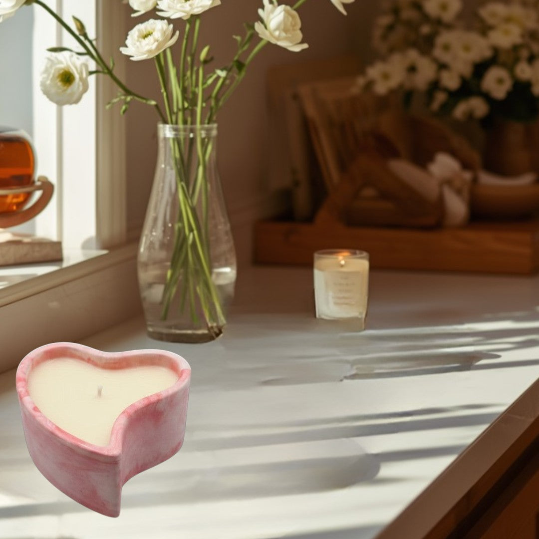 Doodlations Coffee Bar & Boutique marbled pink heart-shaped candle for cozy evenings.