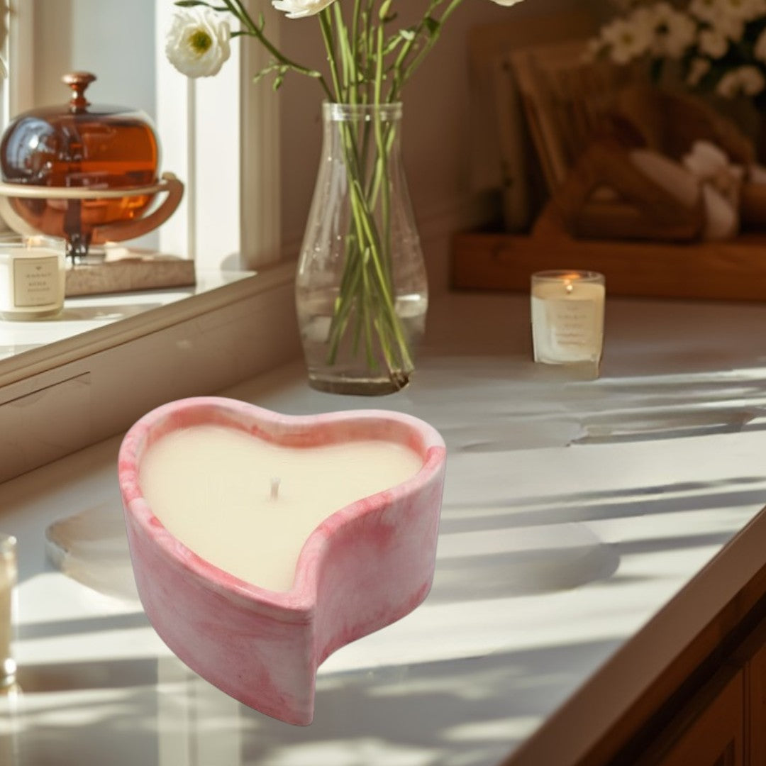 Doodlations Coffee Bar & Boutique marbled pink heart-shaped candle for cozy evenings.