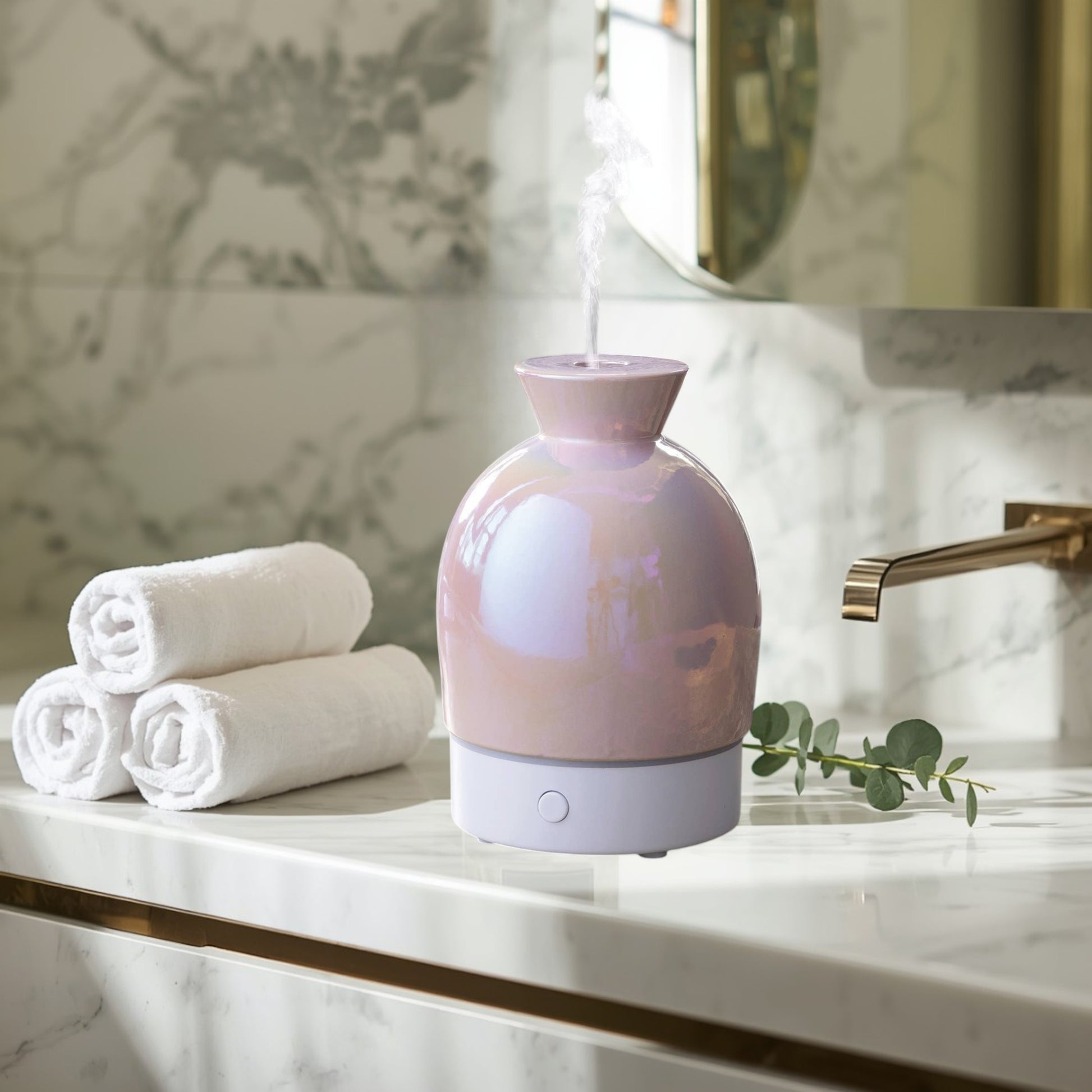 Doodlations Coffee Bar & Boutique iridescent pearlescent aromatic diffuser with white base, emitting mist.