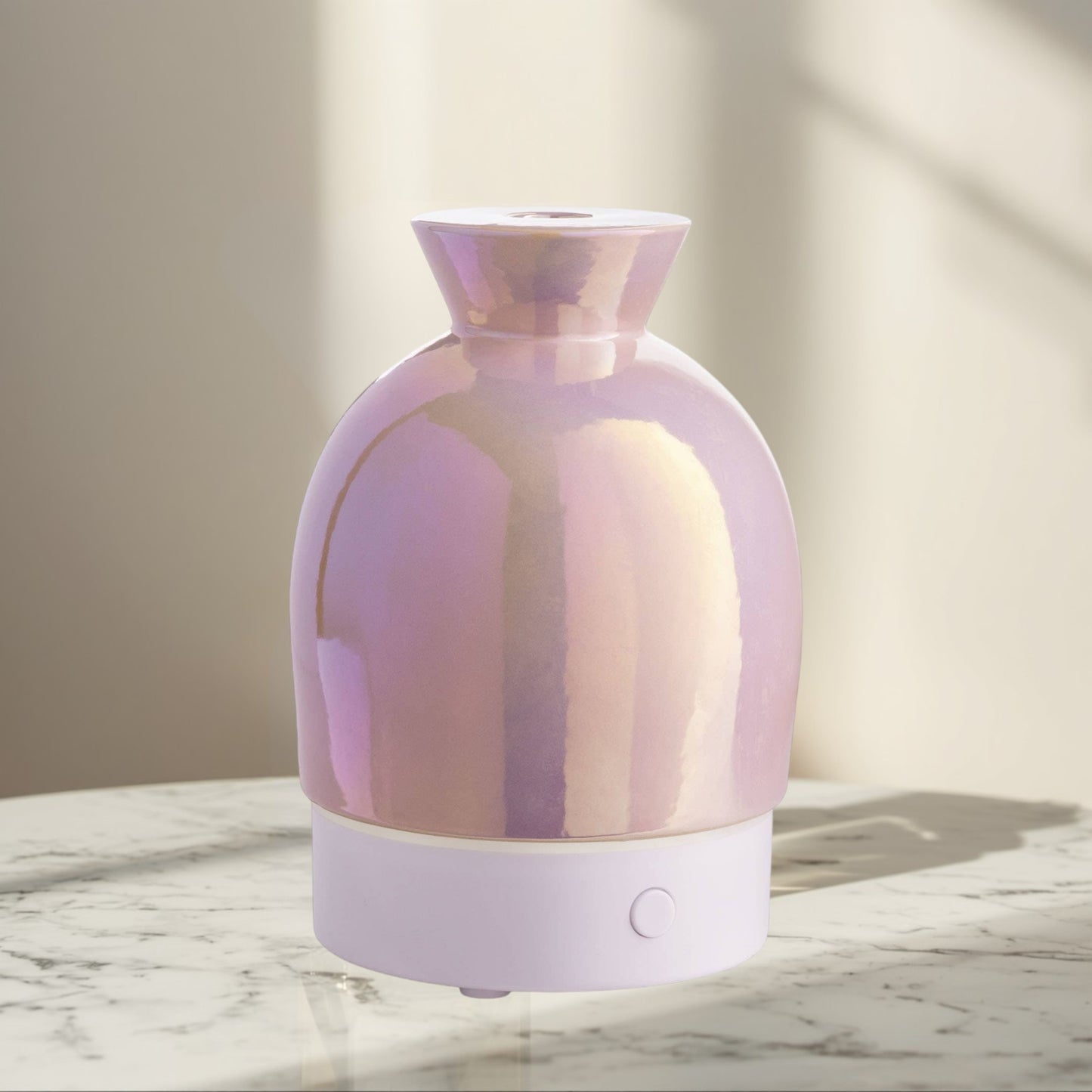 Doodlations Coffee Bar & Boutique iridescent aromatic diffuser with pearlescent hues and a white base.