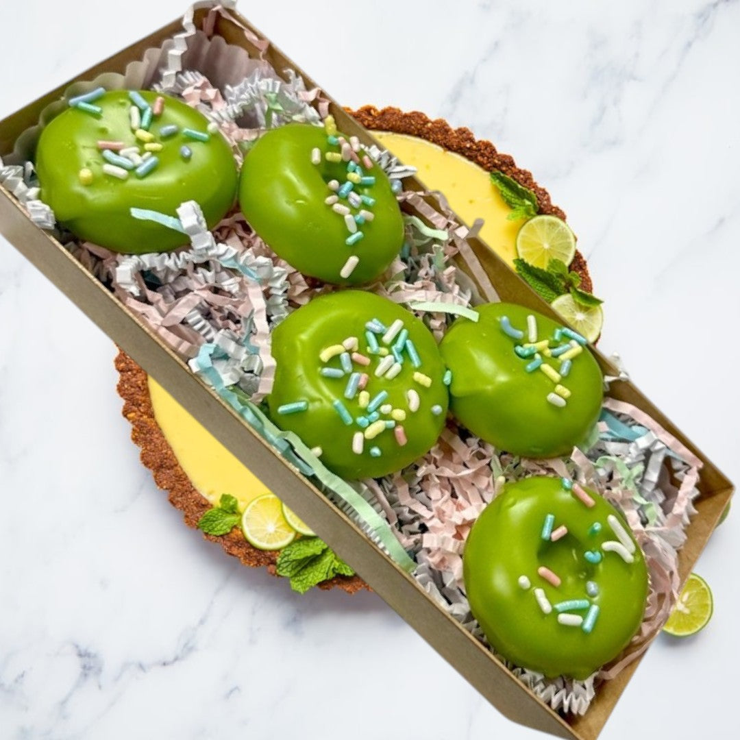 Doodlations Key Lime Donut wax melts in a box, shaped like donuts with green icing and colorful sprinkles.