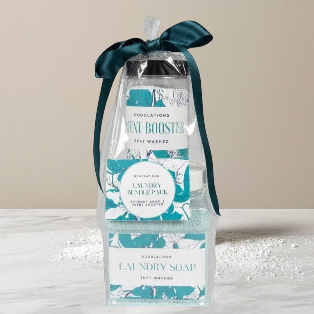 Doodlations Coffee Bar & Boutique laundry bundle with powdered detergent and scent booster in teal packaging, tied with a dark green ribbon.