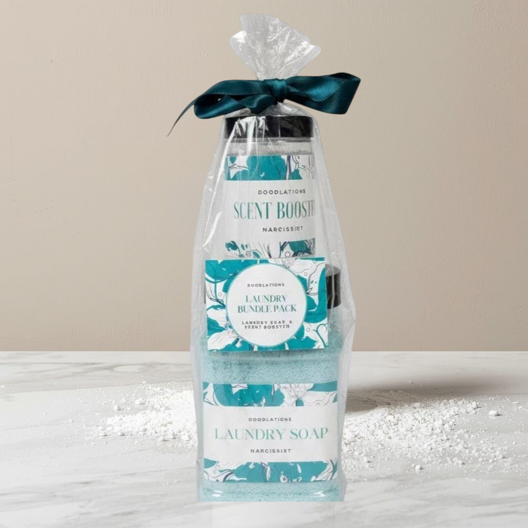 Doodlations Laundry Bundle pack with powdered laundry soap and scent booster in Narcissist scent, packaged in clear plastic with a teal ribbon.
