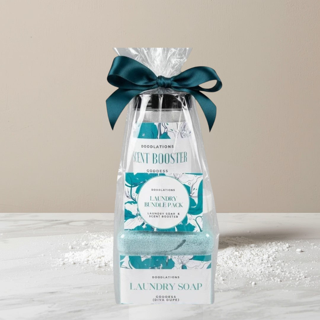 Doodlations Coffee Bar & Boutique laundry bundle with powdered detergent and scent booster in teal packaging, tied with a dark green ribbon.