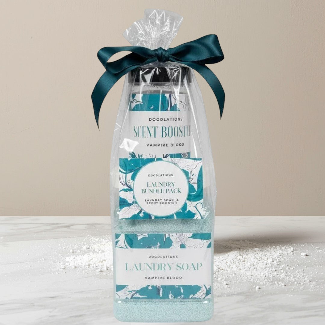Doodlations Coffee Bar & Boutique laundry bundle featuring powdered detergent and scent booster in 'Vampire Blood' scent, packaged with a teal ribbon.