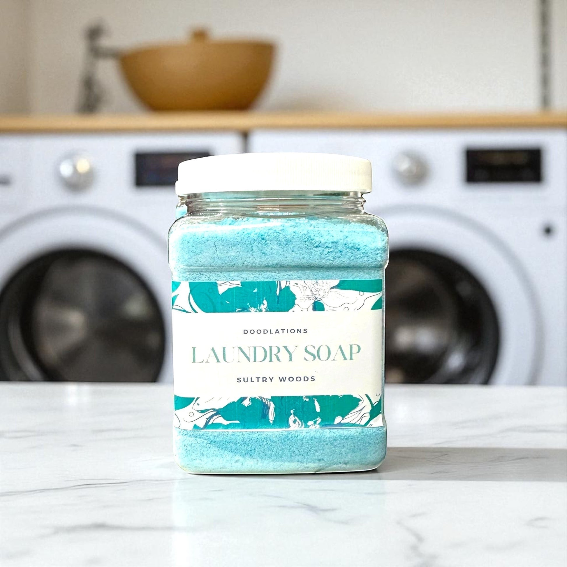 Doodlations Powder Laundry Detergent in Sultry Woods scent, a bright blue powder in a clear jar with a white lid. The label features floral designs and text.