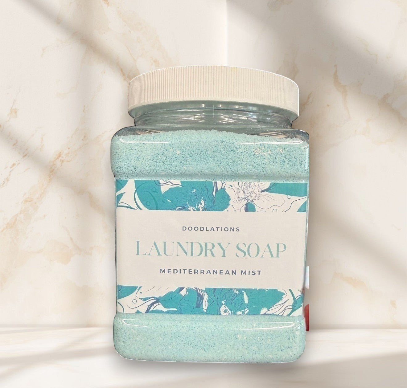 Laundry detergent powder in a clear plastic jar with a white lid.