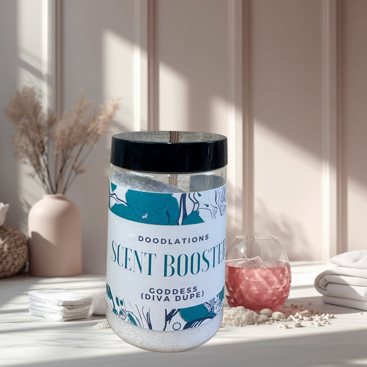 Doodlations Laundry Scent Booster in Goddess scent, a white granular product in a clear jar with a floral label.