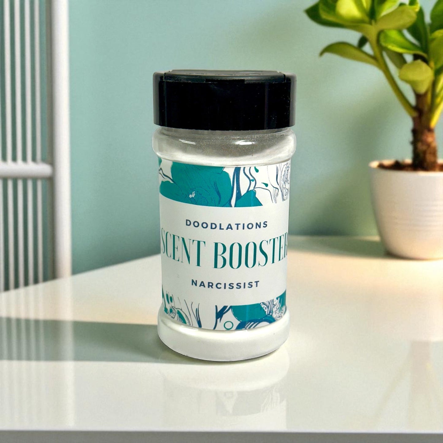 Doodlations Narcissist laundry scent booster in a clear plastic bottle with a black lid and floral design.