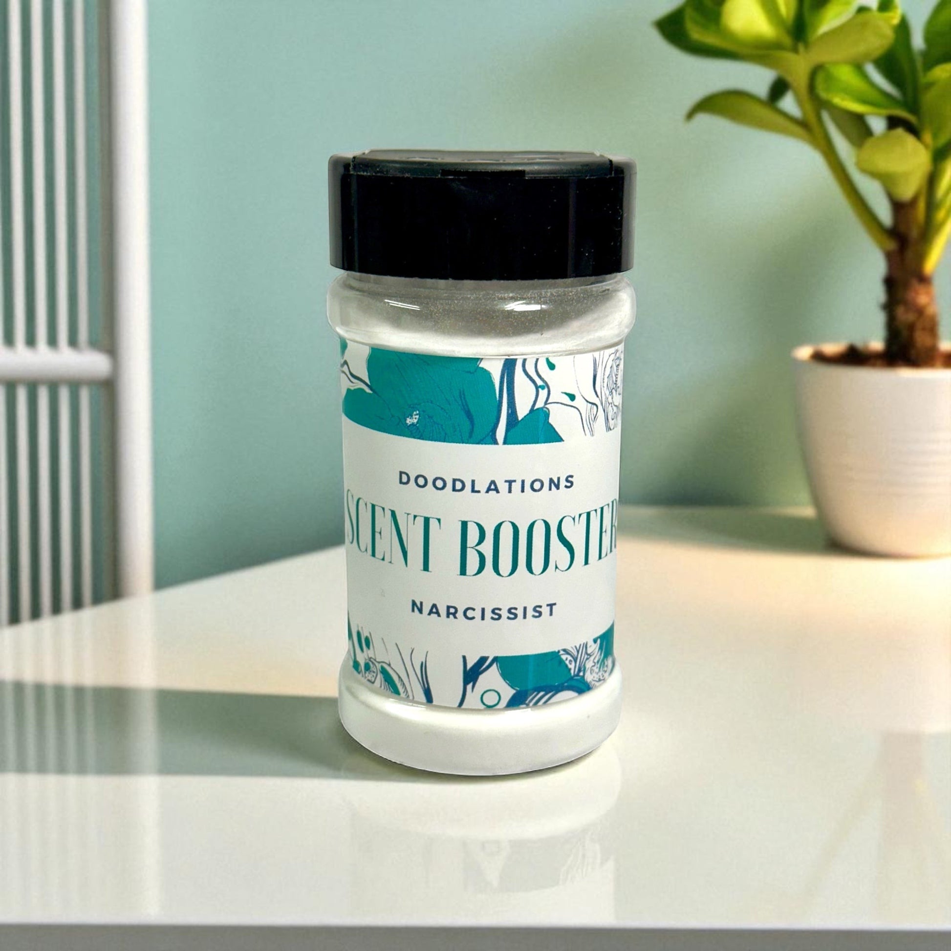 Doodlations Narcissist laundry scent booster in a clear plastic bottle with a black lid and floral design.