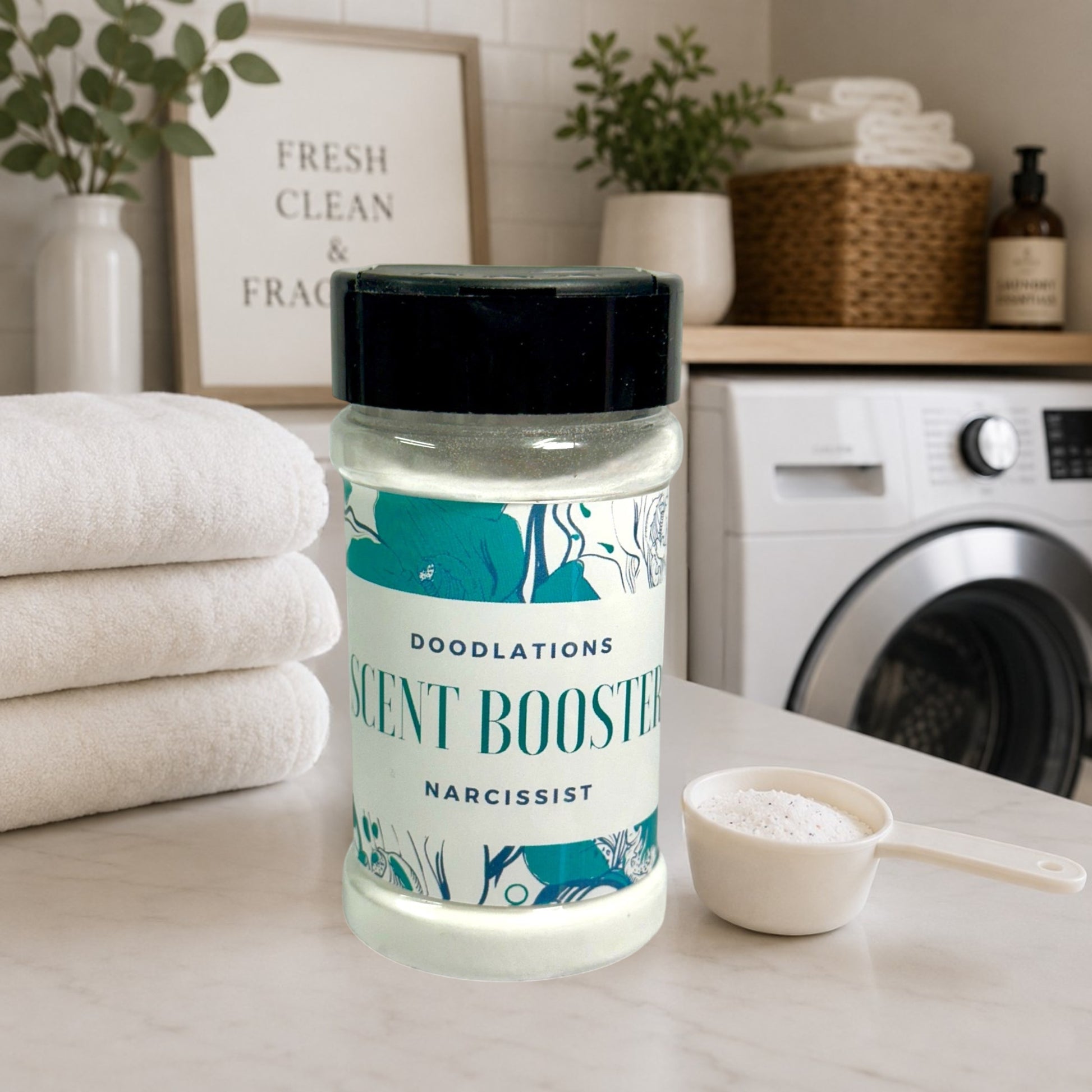 Doodlations Narcissist laundry scent booster in a clear plastic bottle with a black lid. Features floral designs.