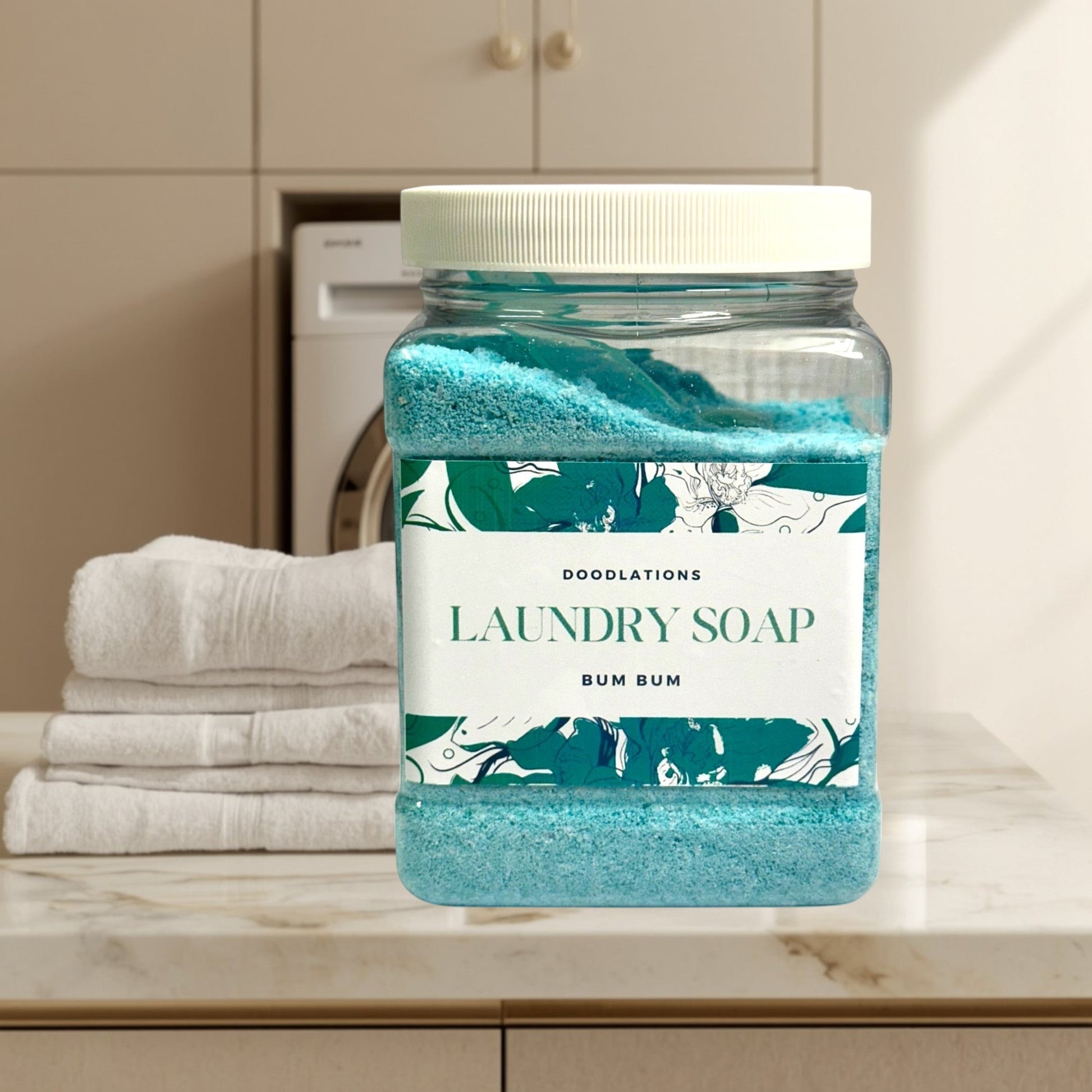 Doodlations Luxury Laundry Soap Bum Bum, a blue granular detergent in a clear plastic jar with a white lid.