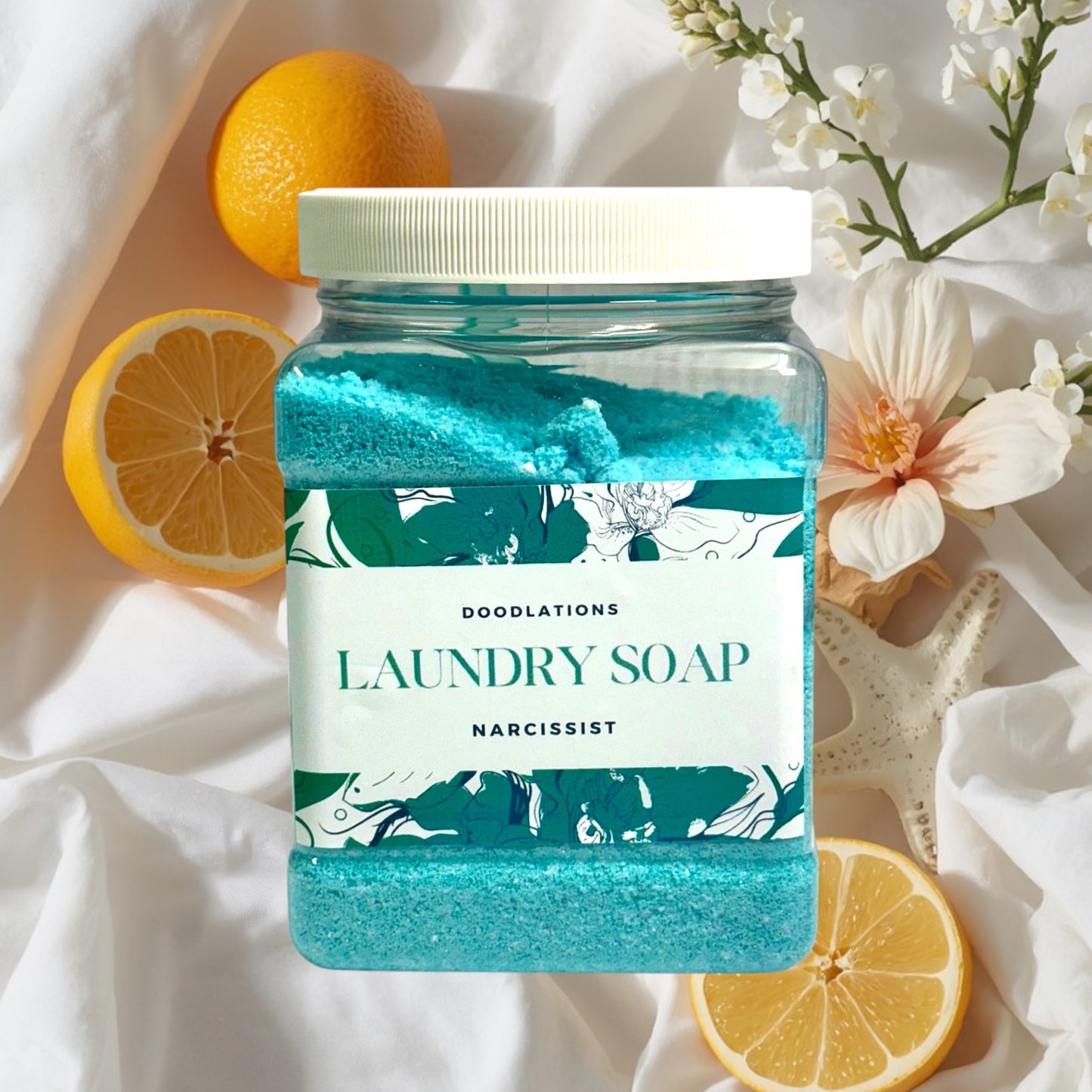 Doodlations Narcissist luxury laundry soap powder in a clear jar with a white lid. Blue powder with floral label.