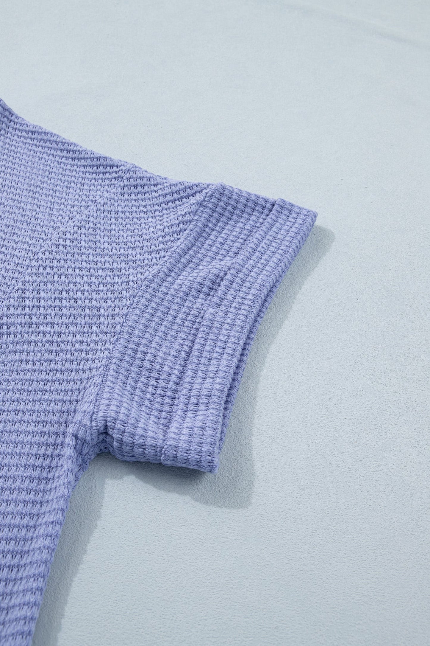 Doodlations Coffee Bar & Boutique lavender waffle knit V-neck top with cuffed short sleeves.