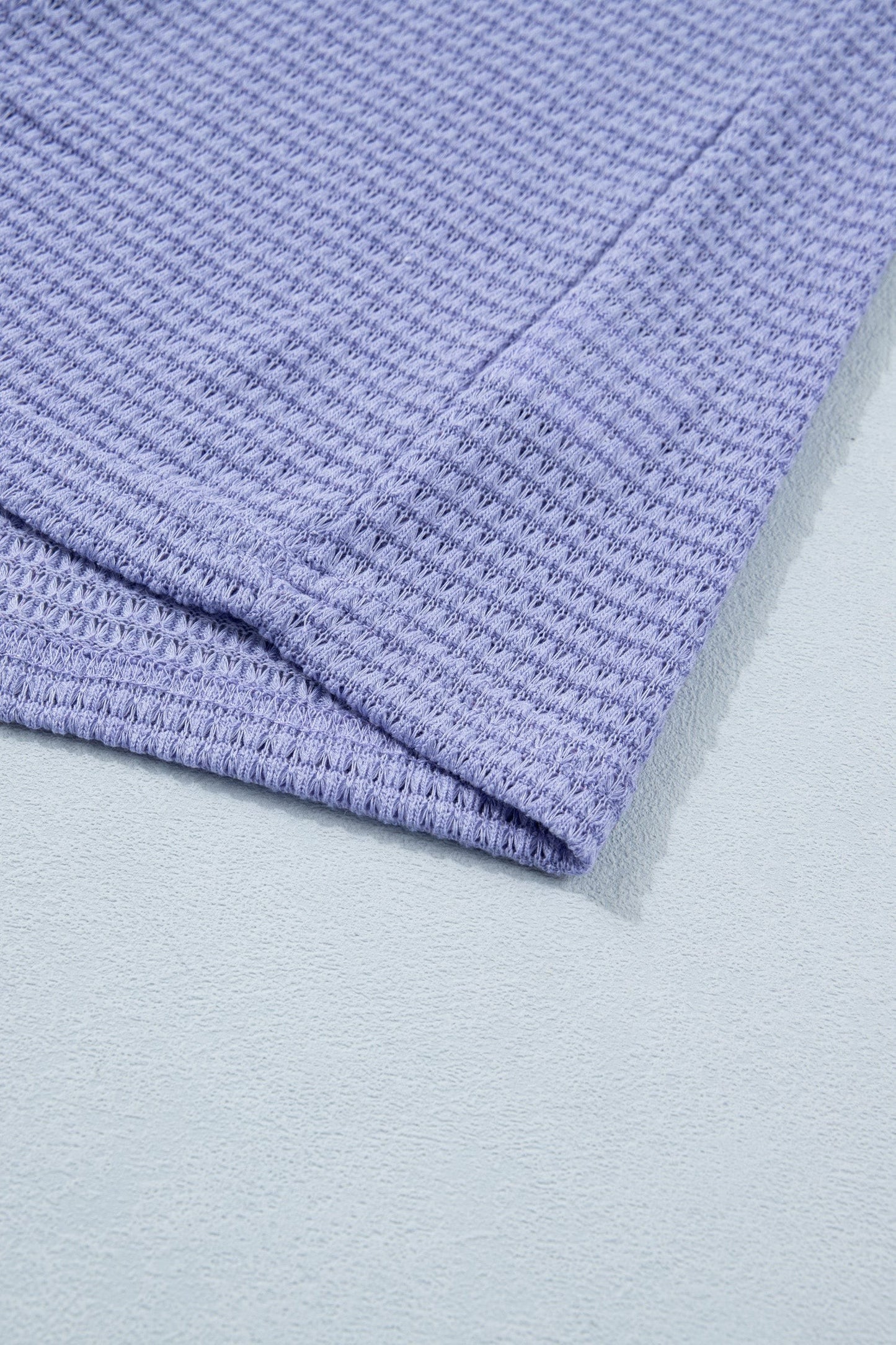 Doodlations Coffee Bar & Boutique lavender waffle knit V-neck top with cuffed short sleeves.