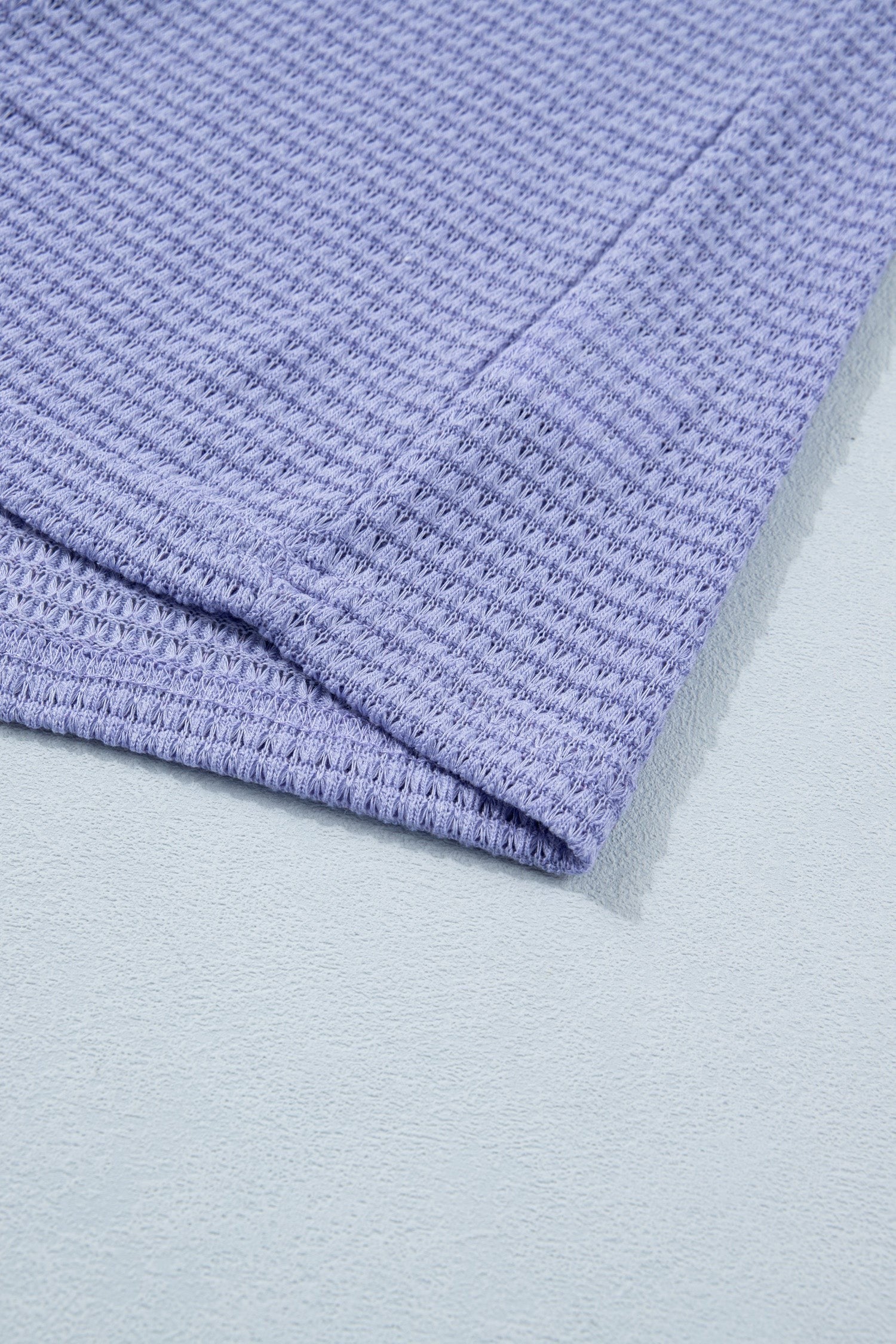 Doodlations Coffee Bar & Boutique lavender waffle knit V-neck top with cuffed short sleeves.
