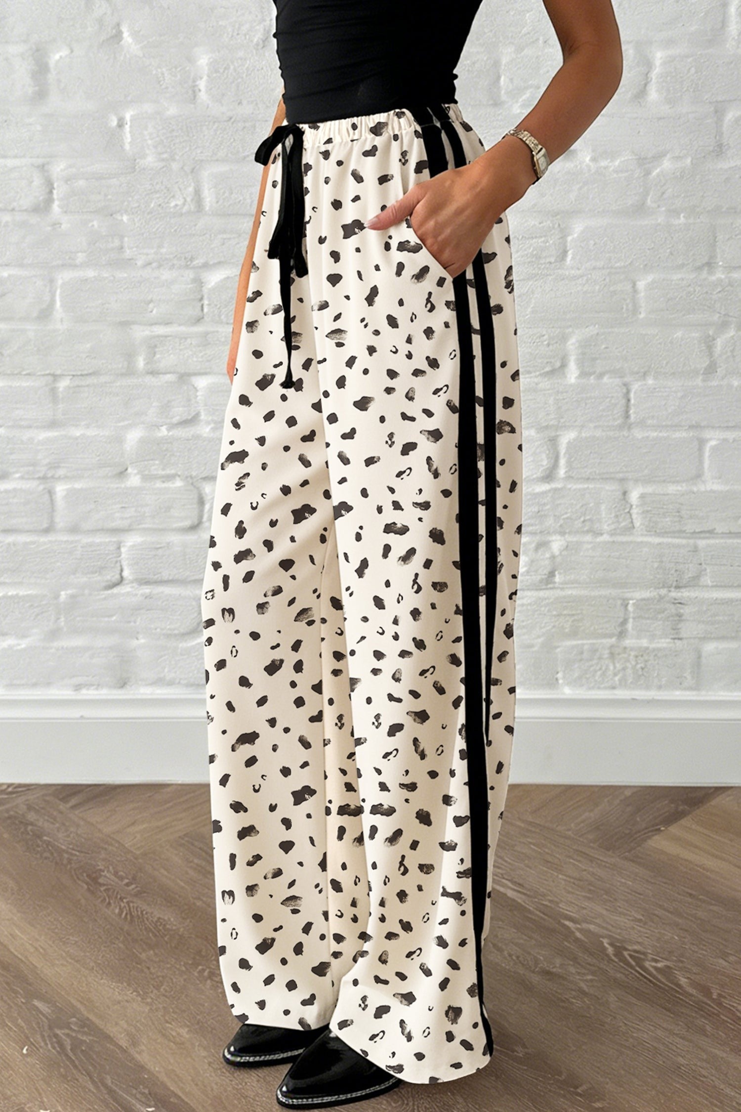 Doodlations Coffee Bar & Boutique beige leopard print loose drawstring pants with black side stripes and adjustable tie waist.