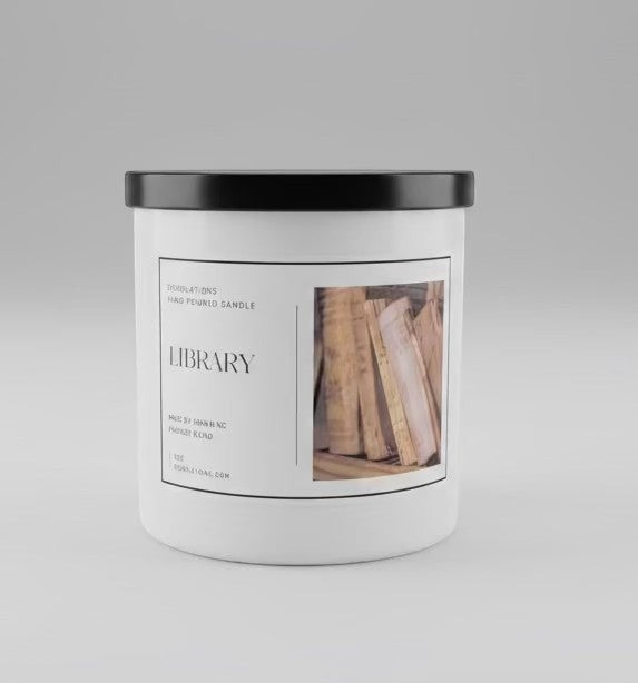 Library hand-poured boutique candle with a sophisticated woodsy scent, in a white jar with a black lid.