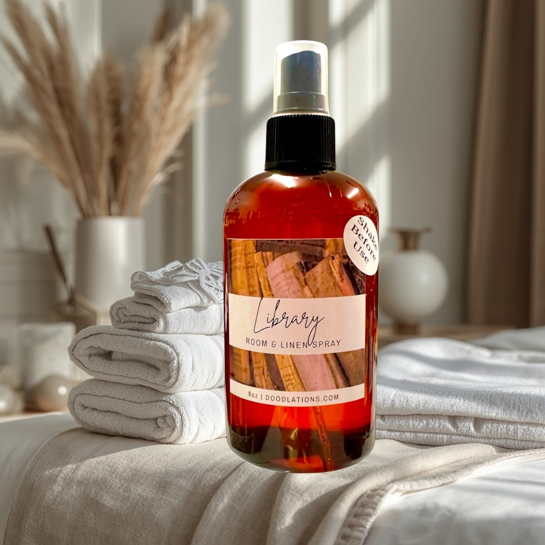 Doodlations Coffee Bar & Boutique Library Room & Linen Spray with teakwood, cedar, leather, sandalwood, musk, and patchouli notes.